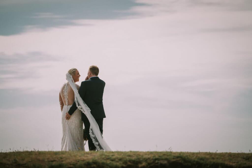 Real Bride Jamielle wearing her Custom Harriett Falvey Wedding Dress and Veil Made in New Zealand